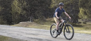 A man rides a mountain bike along a cycle path